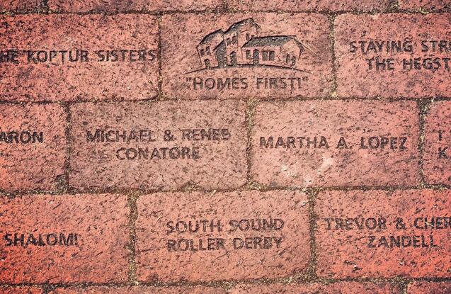 Picture of red bricks inscribed with names of donors 